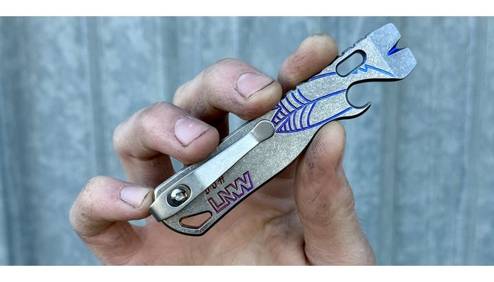 Lynch Northwest All Access Pass titanium pry bar with its clip, held in a hand